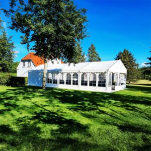 Stor hvidt festtelt på 6x12 meter opstillet i have med hus på græsplæne i Aalborg.